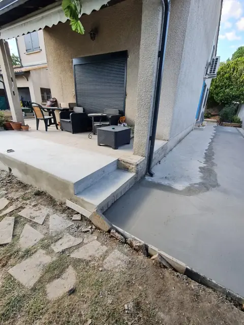 Terrasse béton avec marches réalisée devant une maison